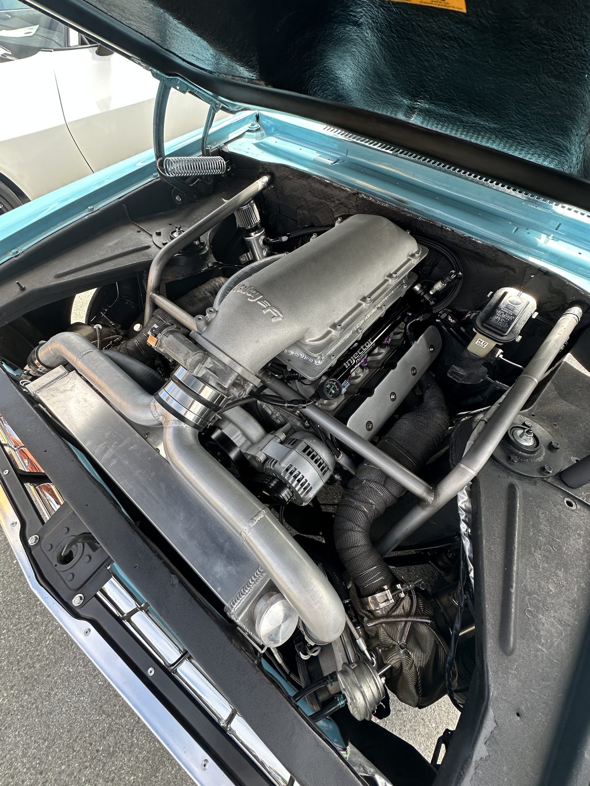 Nova engine bay — twin-turbo 327 LS on Holley